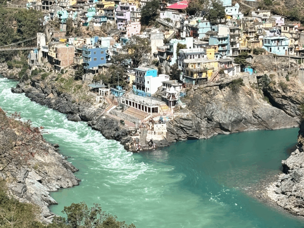River flowing through a mountainous town with colorful houses.