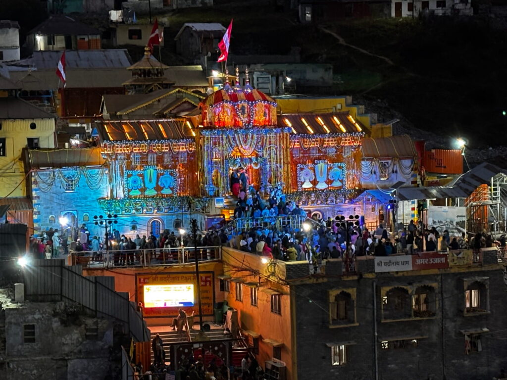 Temple illuminated during a festive night celebration.